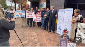 Trains North president Matthew Tierney addresses protesters outside Armidale Regional Council chambers before a decision on funding the first stage of the rail trail.