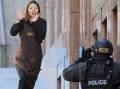 Siege hostage Elly Chen runs from the Lindt Chocolat cafe in Martin Place. Picture: AAP Image/Joel Carrett