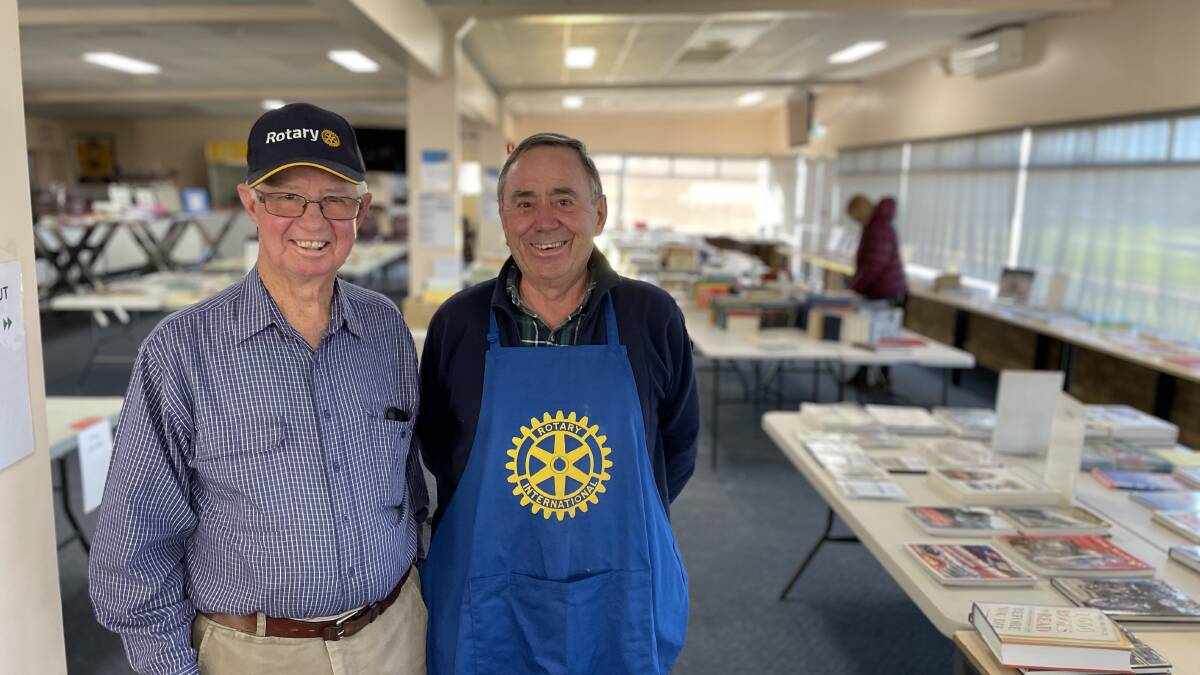 Ian Garske (left) and Graeme Fordham (right) and two of the dozens of hard working volunteers raising thousands of dollars for charity through the Rotary book fair in Armidale. Picture Heath Forsyth 