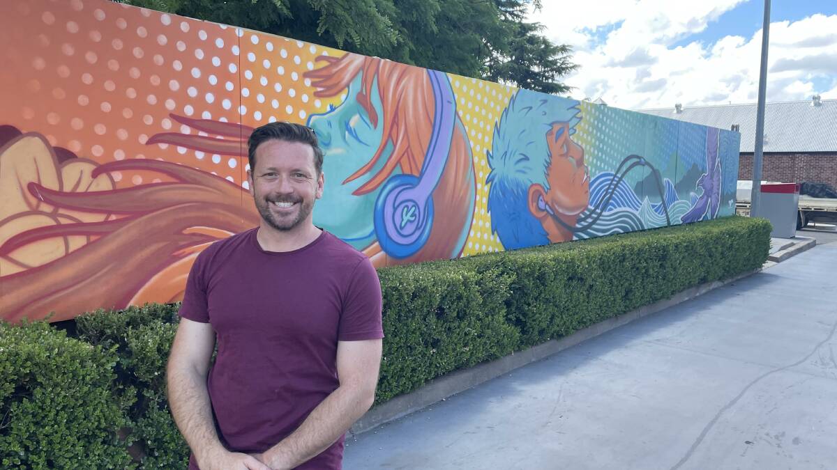 Street Artist James O'Hanlon in front of his mural in the McDonald's car park Armidale. James's work along with CRISP and Silly Pear have their work on display at NERAM Photo Heath Forsyth 