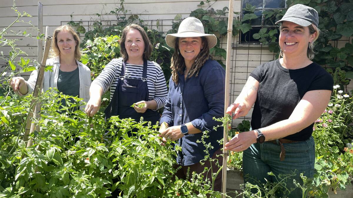 From left, Armidale Food Group Cooperative member Nikki Larder, local gardener Sally Dixon and cooperative members Mac Williams and Jennifer Hamilton do some last minute weeding and pruning before the weekend tours.