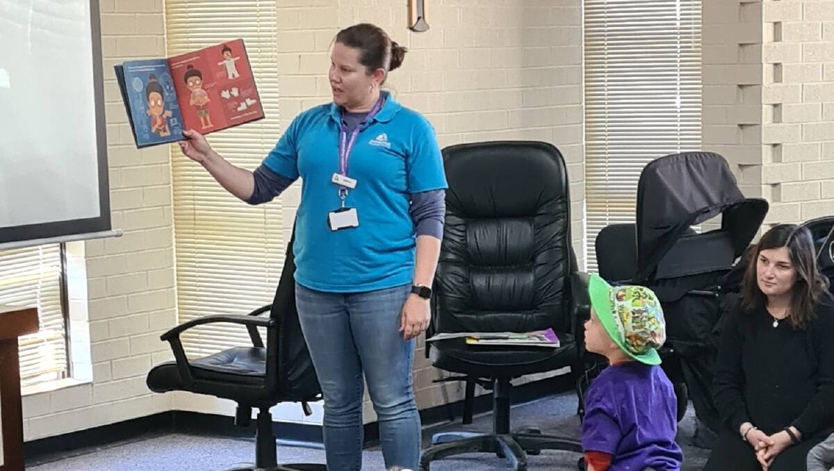 Armidale Regional Council's Aimee Hutton reads at the National Simultaneous Storytime event at Guyra Library.