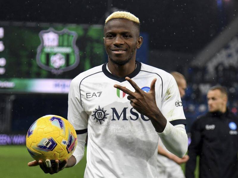 Napoli's Victor Osimhen takes home the matchball after his hat trick downed Sassuolo in Serie A. (AP PHOTO)