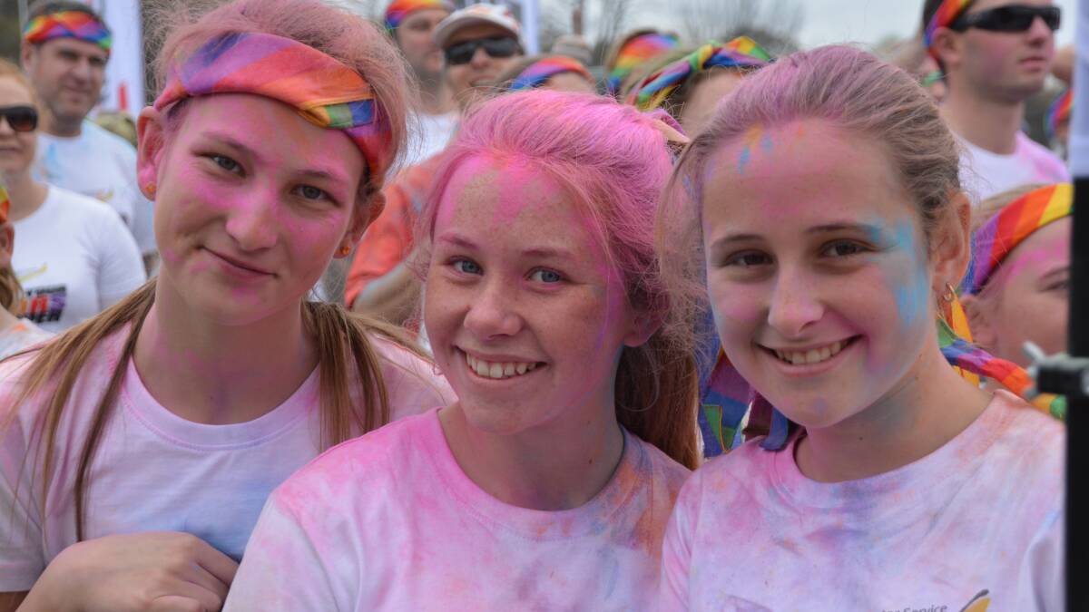 TICKLED PINK: Maddy Roberts, Bronte McCann and Molly Kratz were among hundreds of runners in the Show Your Colours run.