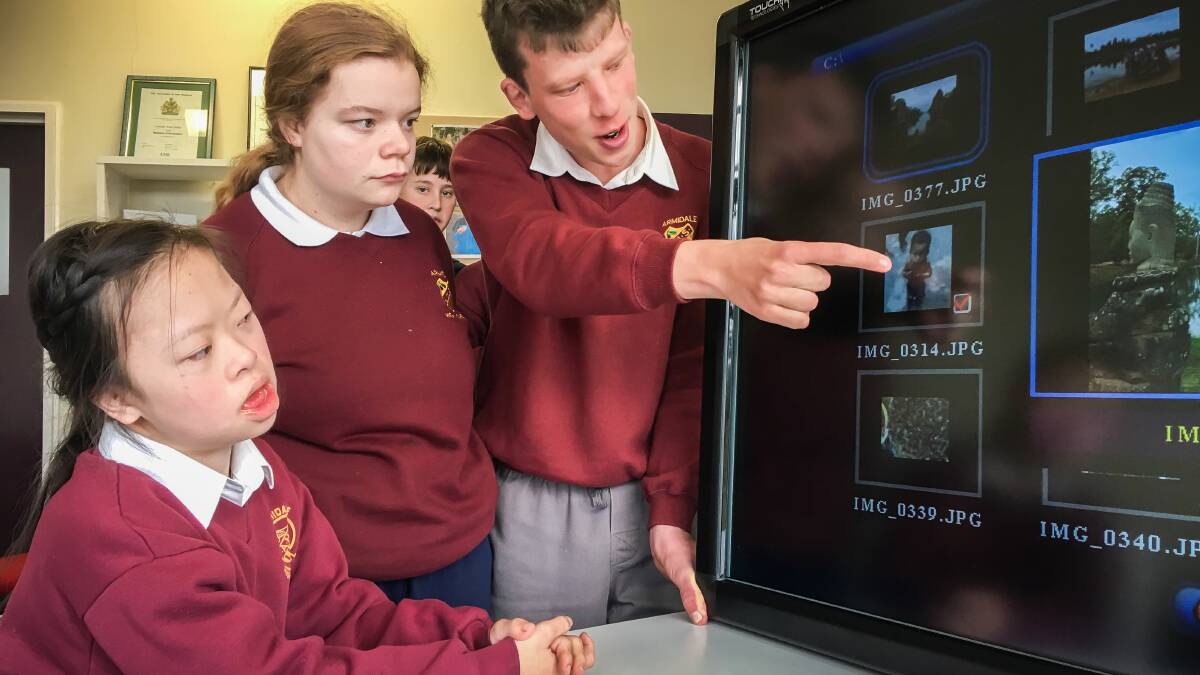 ON POINT: Kerry Ho, year 9, student Onaya Parsons, year 11 and Jock Jarman, year 10, check out Armidale High’s new touch screen television.