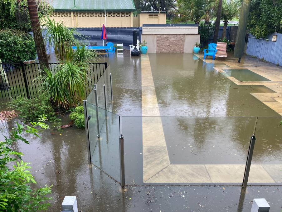 PHOTO GALLERY: Flooding along Collins Street in North Narrabeen. Pictures: Jake Downs